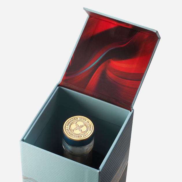open box of the lakes signature single malt whisky showing the top of the glass bottle with gold quatrefoil stopper